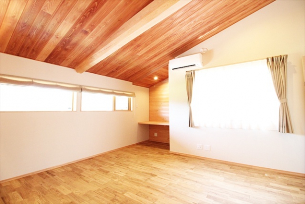 2階寝室には勾配天井と丸太梁